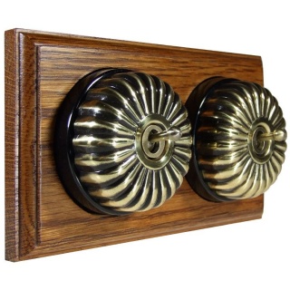 2 Gang 2 Way Antique Brass Fluted Dome with Black Pattress on Horizontal Med Oak Base