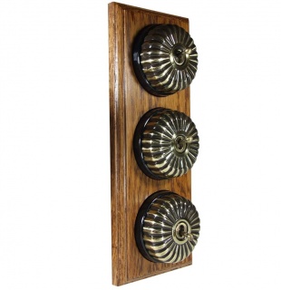 3 Gang 2 Way Antique Brass Fluted Dome with Black Pattress on Vertical Medium Oak Base