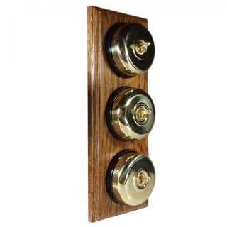 3 Gang 2 Way Polished Brass Smooth Dome with Black Pattress Vertical Medium Oak Base